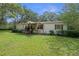 Inviting single-Gathering home featuring a cozy front porch and a lush green yard at 8248 Irene St, Zephyrhills, FL 33540