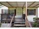 Close-up of the home's covered front porch with steps leading up to the entry at 8248 Irene St, Zephyrhills, FL 33540
