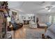 Open-concept living room with hardwood floors, a fireplace, and ample seating at 8248 Irene St, Zephyrhills, FL 33540