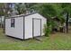 Exterior view of a shed featuring neutral siding, a window, and a single door at 8248 Irene St, Zephyrhills, FL 33540