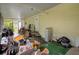 Enclosed porch featuring a concrete floor, screened windows, and a back door at 8248 Irene St, Zephyrhills, FL 33540