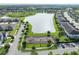 The aerial view features a playground, large pond and common areas of a neighborhood, illustrating Gathering-friendly amenities at 9140 Hillcroft Dr, Riverview, FL 33578