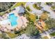 Aerial view of a community pool and playground with ample seating and parking at 9140 Hillcroft Dr, Riverview, FL 33578