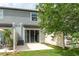 View of the back patio with sliding glass doors, a tree and partial privacy fence at 9140 Hillcroft Dr, Riverview, FL 33578