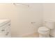 Powder bathroom features tiled floor, toilet, vanity and towel rack at 9140 Hillcroft Dr, Riverview, FL 33578