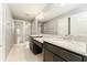 Bathroom featuring double granite vanity, large mirror, and a glass enclosed shower at 9140 Hillcroft Dr, Riverview, FL 33578
