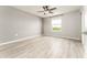 Spacious bedroom with ceiling fan, light walls, window and wood-look floors at 9140 Hillcroft Dr, Riverview, FL 33578