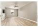 Bedroom featuring light wood floors, a ceiling fan, and a window for natural light at 9140 Hillcroft Dr, Riverview, FL 33578