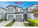 Charming gray two-story home with attached two-car garage and landscaped yard at 9140 Hillcroft Dr, Riverview, FL 33578