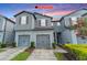 Charming gray two-story home with attached two-car garage and landscaped yard at dusk at 9140 Hillcroft Dr, Riverview, FL 33578