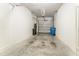 Clean and functional garage with white concrete block walls and gray concrete floor at 9140 Hillcroft Dr, Riverview, FL 33578