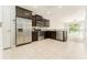 Stylish kitchen offers stainless steel appliances, dark cabinets, and a breakfast bar overlooking a bright living area at 9140 Hillcroft Dr, Riverview, FL 33578