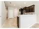 Modern kitchen features stainless steel appliances, tile floors, and granite countertops at 9140 Hillcroft Dr, Riverview, FL 33578