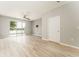 Inviting living area with wood floors and sliding glass doors that provide serene lake views at 9140 Hillcroft Dr, Riverview, FL 33578