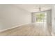 Spacious living room features laminate floors, ceiling fan and sliding glass doors at 9140 Hillcroft Dr, Riverview, FL 33578