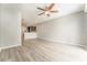 Large living room features laminate floors, ceiling fan, view of kitchen and lots of space at 9140 Hillcroft Dr, Riverview, FL 33578