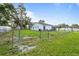 Expansive fenced backyard featuring a well-maintained lawn, mature trees, and plenty of room for outdoor activities at 9511 N Hyaleah Rd, Tampa, FL 33617