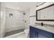 Bathroom featuring a sleek shower with gray tiling, modern fixtures, and stylish vanity at 9511 N Hyaleah Rd, Tampa, FL 33617