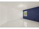 Bright bedroom features a modern accent wall, ample natural light and sleek tile flooring at 9511 N Hyaleah Rd, Tampa, FL 33617