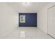 Bright bedroom features a modern accent wall, ample natural light and sleek tile flooring at 9511 N Hyaleah Rd, Tampa, FL 33617