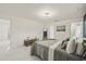 A modern bedroom featuring white walls, marble floors, stylish decor, and a comfortable bed at 9511 N Hyaleah Rd, Tampa, FL 33617