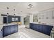 Contemporary kitchen with dual-tone cabinets, stainless steel appliances, and open layout at 9511 N Hyaleah Rd, Tampa, FL 33617