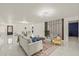 Bright living room highlighting contemporary decor, marble floors, and a cozy seating area at 9511 N Hyaleah Rd, Tampa, FL 33617