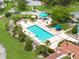 An aerial view showcasing the community pool and amenity center, surrounded by lush landscaping and relaxation areas at 9800 Sago Point Dr, Seminole, FL 33777