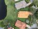 Aerial view of the property showing the home's layout, surrounding greenery, and proximity to a peaceful lake at 9800 Sago Point Dr, Seminole, FL 33777