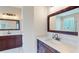 Stylish bathroom featuring marble countertops, dark wood cabinets, and modern fixtures at 9800 Sago Point Dr, Seminole, FL 33777
