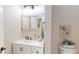 Bathroom with a white vanity, a decorative mirror, and ocean-themed accents at 9800 Sago Point Dr, Seminole, FL 33777
