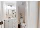 Bathroom with a white vanity, a decorative mirror, and ocean-themed accents at 9800 Sago Point Dr, Seminole, FL 33777