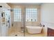 Bright bathroom showcasing a walk-in shower, soaking tub, and marble countertops at 9800 Sago Point Dr, Seminole, FL 33777