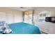 Bright bedroom featuring a ceiling fan, sliding doors to the balcony, and beautiful view of the lake at 9800 Sago Point Dr, Seminole, FL 33777