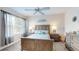 Comfortable bedroom with ceiling fan, wood furniture, and cool ocean-themed décor at 9800 Sago Point Dr, Seminole, FL 33777