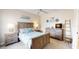 Bright bedroom featuring a wooden bed frame, ceiling fan, and a matching dresser at 9800 Sago Point Dr, Seminole, FL 33777