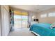 Bright bedroom featuring a ceiling fan, sliding doors to the balcony, and beautiful view of the lake at 9800 Sago Point Dr, Seminole, FL 33777