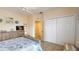 Bedroom featuring a spacious closet, a dresser with a TV, and light-colored carpet at 9800 Sago Point Dr, Seminole, FL 33777