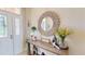 Elegant foyer with a decorative mirror and a stylish table, creating a warm and inviting ambiance at 9800 Sago Point Dr, Seminole, FL 33777