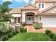 Inviting front entrance with lush landscaping and a charming front patio, creating a welcoming curb appeal at 9800 Sago Point Dr, Seminole, FL 33777