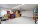 Clean and organized garage with ample storage, work area and epoxy flooring at 9800 Sago Point Dr, Seminole, FL 33777