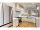 Open kitchen with stone countertops, stainless appliances and view into dining and living areas at 9800 Sago Point Dr, Seminole, FL 33777