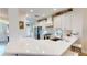 Bright kitchen boasts white cabinets, stainless appliances, and a quartz countertop island with breakfast bar at 9800 Sago Point Dr, Seminole, FL 33777