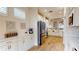 Kitchen with stainless refrigerator, stone countertops, modern appliances and shuttered windows at 9800 Sago Point Dr, Seminole, FL 33777