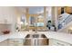 Open concept living space features high ceilings, fireplace and kitchen view with island at 9800 Sago Point Dr, Seminole, FL 33777
