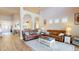 Open-concept living room filled with natural light, featuring hardwood floors and comfortable seating at 9800 Sago Point Dr, Seminole, FL 33777