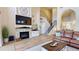 Inviting living room features a stone fireplace, hardwood floors, and an open floor plan with stairs at 9800 Sago Point Dr, Seminole, FL 33777