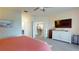 Spacious bedroom featuring a dresser, walk-in closet, and lovely connecting hallway at 9800 Sago Point Dr, Seminole, FL 33777