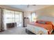 Main bedroom boasting access to a screened patio with waterfront views at 9800 Sago Point Dr, Seminole, FL 33777