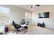 Bright office with neutral walls, a modern desk setup, and a large screen on the wall at 9800 Sago Point Dr, Seminole, FL 33777
